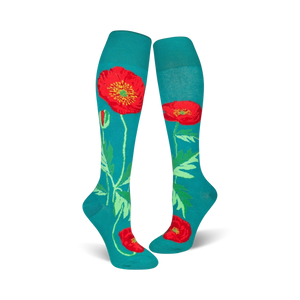 Close-up of teal knee-high socks with a red poppy design.