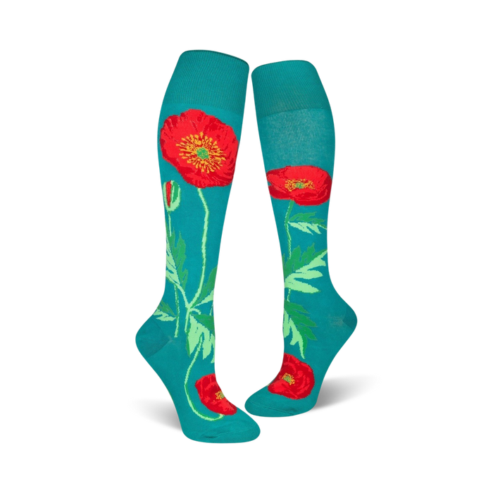 Close-up of teal knee-high socks with a red poppy design.