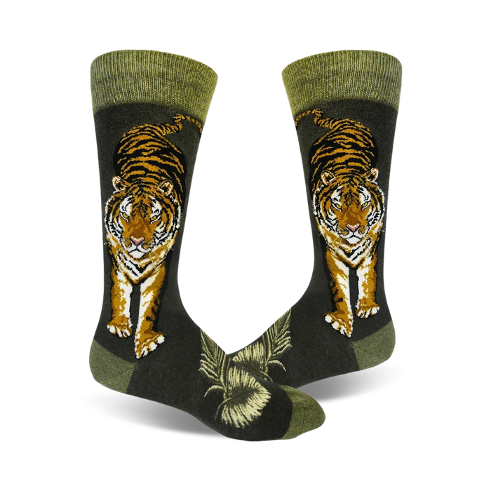 A pair of crew socks with a detailed tiger illustration in orange and black against a dark green background. The socks have a green cuff. }}