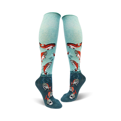Pair of teal knee-high socks adorned with leaping orange salmon and teal waves. A fun and unique design!