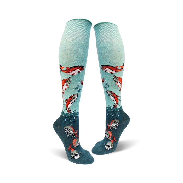 mint green and dark teal knee high socks for women with a pattern of sockeye salmon swimming up from the teal to the mint green part of the sock.    }}