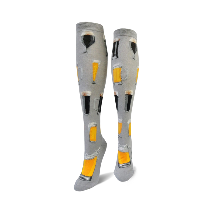 Pair of gray knee-high socks featuring various illustrations of beer steins and glasses filled with light and dark beer. }}