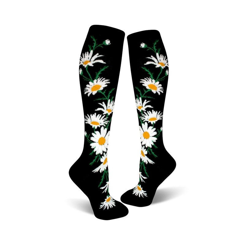 A pair of black knee-high socks with a whimsical pattern of white daisies and green stems.