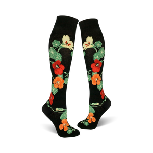 Pair of black knee-high socks with a pattern of orange, red, and yellow nasturtium flowers and green leaves.