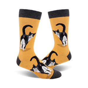 Pair of crew socks; mustard yellow and charcoal grey; featuring a tuxedo cat's rear end, repeated pattern.