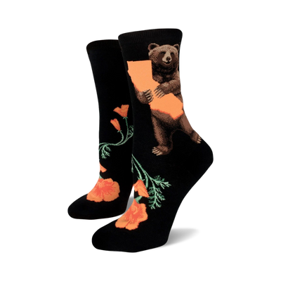 A pair of black crew socks with an illustration of a bear hugging the California outline and orange California poppies.
