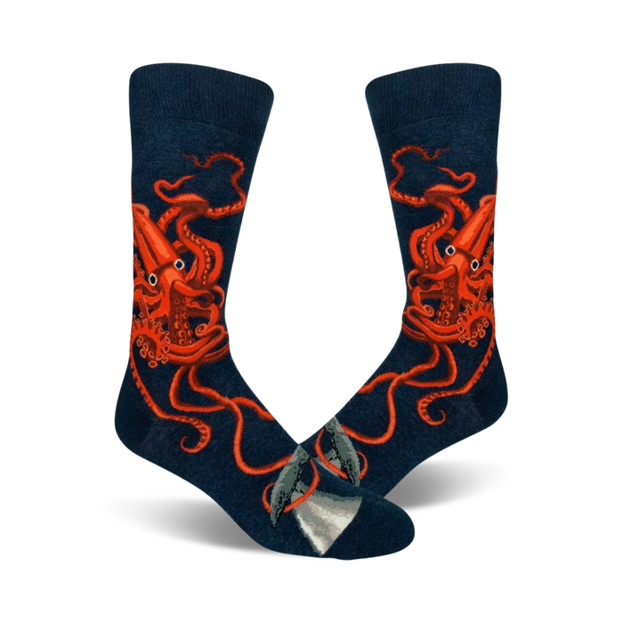 A pair of navy blue crew socks with a detailed illustration of a giant squid in bright orange. A small whale is visible near the toes. }}