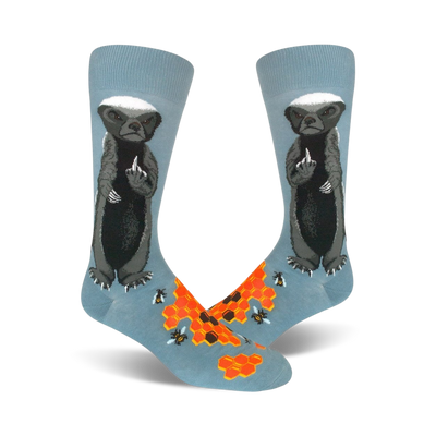 Pair of crew socks; light blue with a honey badger giving the middle finger, honeycomb, and bees illustrated.