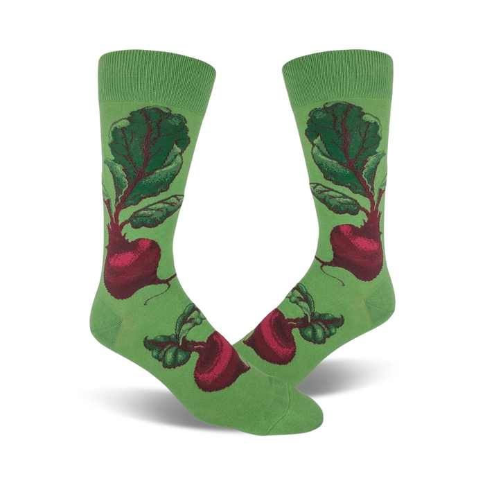 A pair of crew socks showcasing a whimsical illustration of red beets on a green background. The beets are detailed and vibrant against the soft green fabric. }}