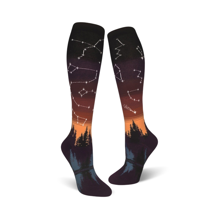 Lifestyle shot: A person's feet wearing the orange and purple Constellations socks with the design visible.
