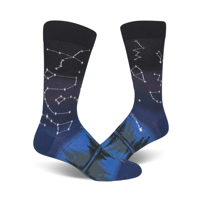 men's crew socks featuring a dark blue background and a pattern of white and light blue constellations and evergreen trees.    }}