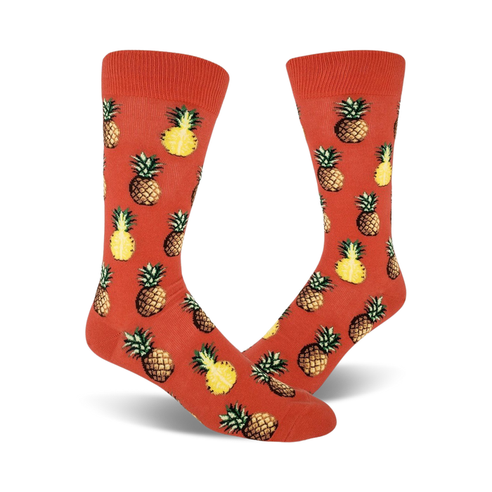 mens orange crew socks with pineapple pattern in yellow and green.   