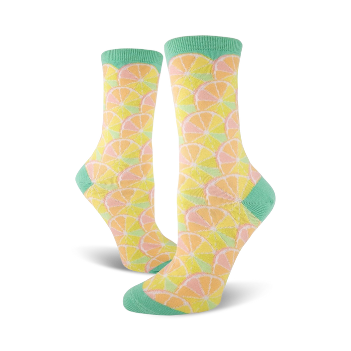 citrus crew socks in orange slices pattern, pale yellow background, and mint green toes and heels.   