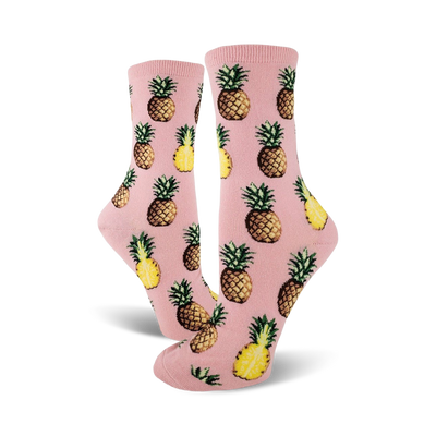 Pair of crew socks; pink and yellow pineapples on a pink background. Fun pineapple print socks.