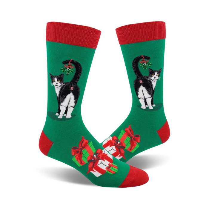 green socks with a red top, black cat with tail up, red and white presents, and mistletoe.     }}
