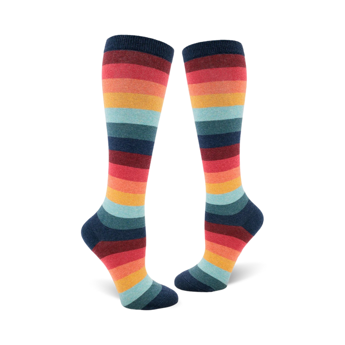 Pair of women's knee-high socks in a retro rainbow stripe pattern. Colors include teal, orange, red, and dark blue. }}