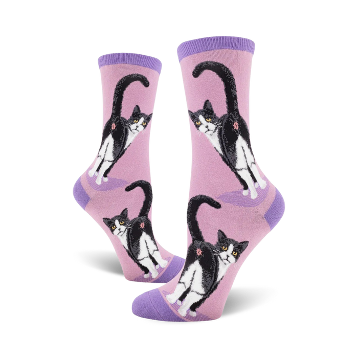 Pair of women's crew socks, pink and purple, featuring a repeated pattern of tuxedo cats' backsides.