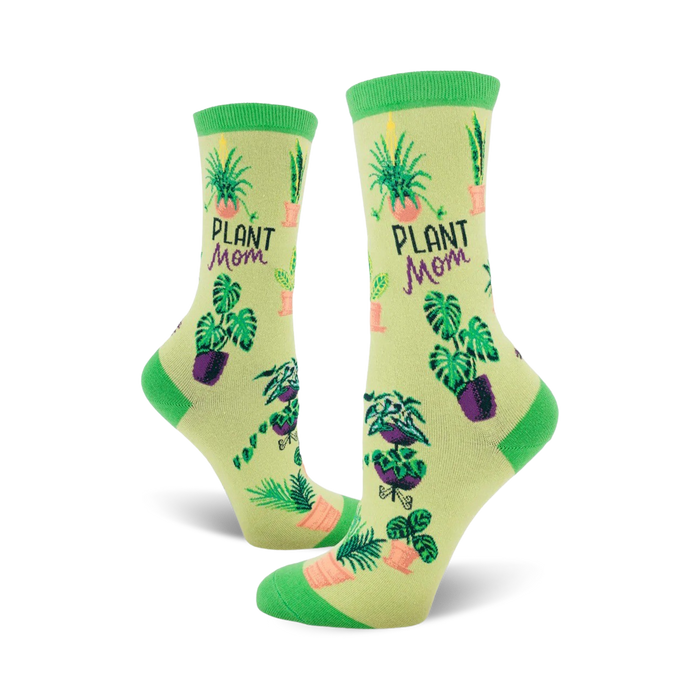 A pair of women's crew socks in pastel green with illustrations of various potted plants and the text 'Plant Mom'. }}