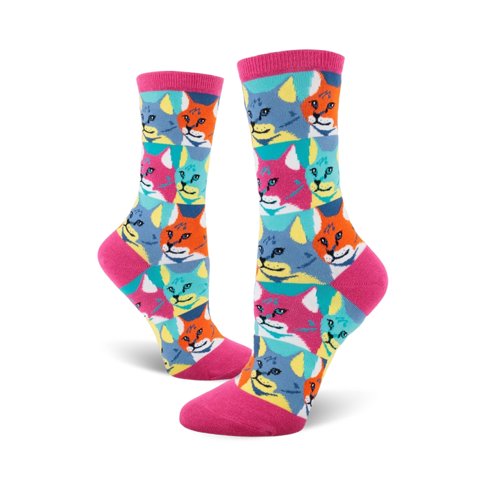 Crew socks with a Pop Art design. Features repeating patterns of cats in teal, orange, pink and yellow against a white background. }}