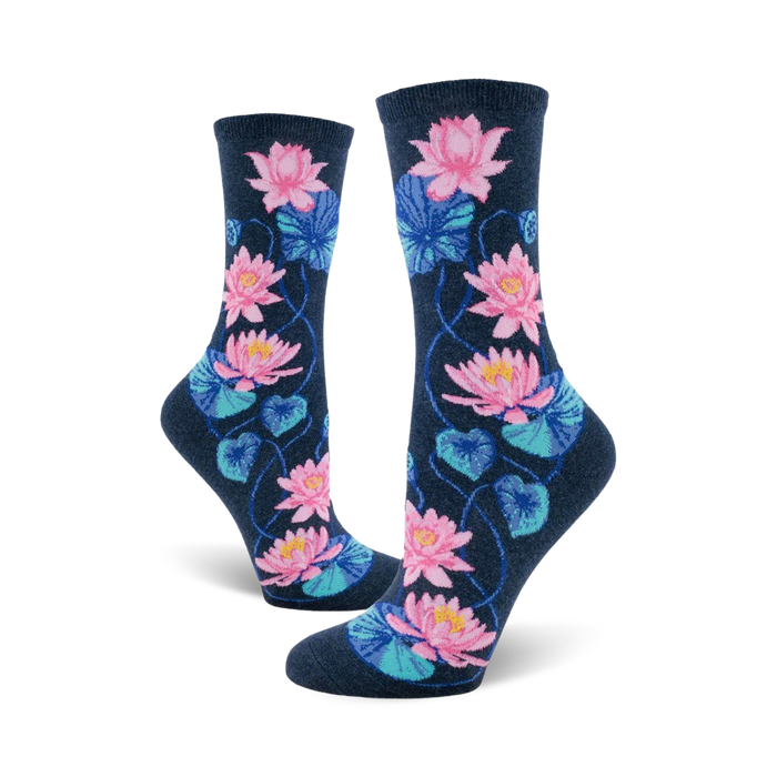 A pair of women's crew socks in navy blue, decorated with a pattern of pink and teal water lilies and leaves. }}