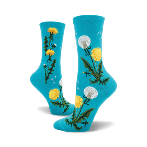 Pair of crew socks in teal and mauve featuring a whimsical dandelion design. Yellow dandelions and seed heads are scattered on a solid background.