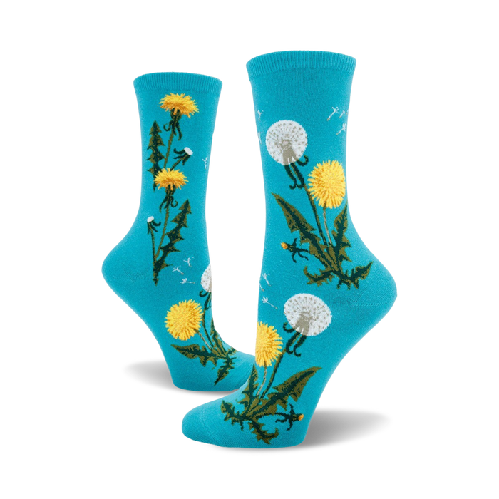 Pair of crew socks in teal and mauve featuring a whimsical dandelion design. Yellow dandelions and seed heads are scattered on a solid background.