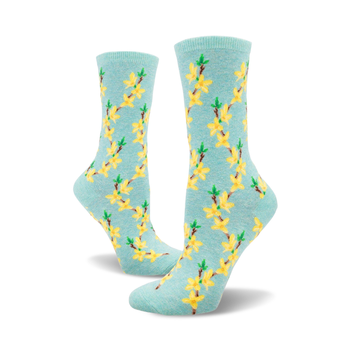 A pair of women's crew socks in pastel blue with a repeating pattern of yellow forsythia flowers and green stems. }}