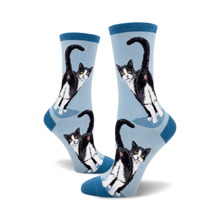 Lifestyle shot showing the light blue Tuxedo Cat Butt socks on a person's feet,  emphasizing the fun design.