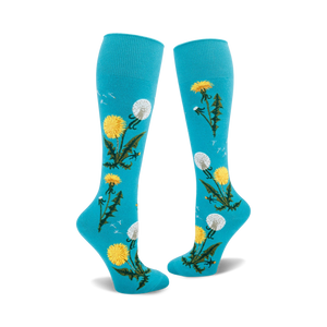 Pair of teal knee-high socks with yellow dandelions and green stems printed on them.  Some dandelions are in seed-head form.