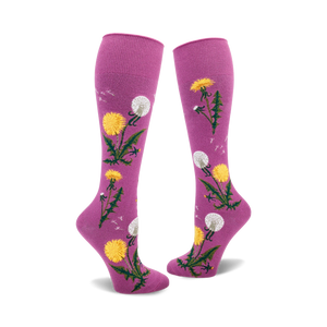Pair of mauve knee-high socks with yellow dandelions and green stems printed on them. Some dandelions are in seed-head form.