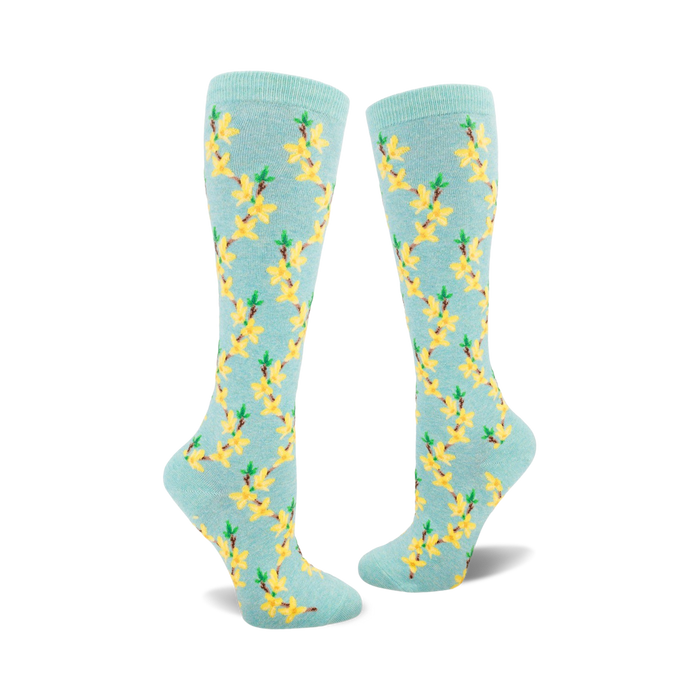 light blue knee high socks with yellow flowers and green leaves.   }}