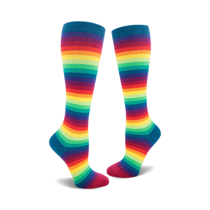 Pair of rainbow striped knee-high socks. Colors include red, orange, yellow, green, blue, indigo, and violet stripes on a dark teal base. }}