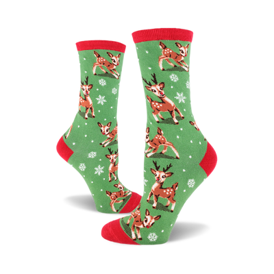 A pair of women's crew socks in green with a red cuff. The socks feature a pattern of cute reindeer and snowflakes.