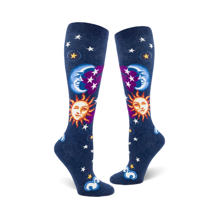 Pair of navy blue knee-high socks with whimsical sun, moon, and stars design. Features smiling sun and moon faces, purple accents, and white stars. }}