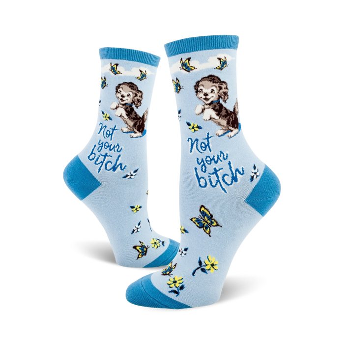 Crew socks in light blue with a cute puppy, butterflies, flowers, and the text 'Not your bitch'. }}