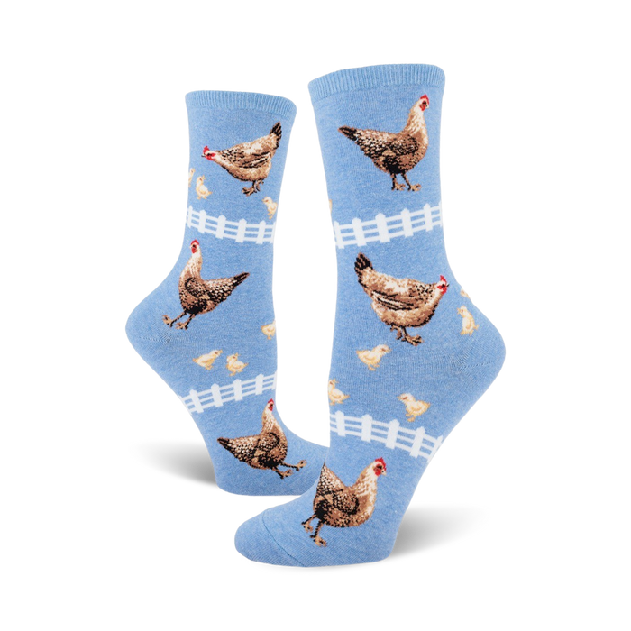 light blue crew socks for ladies feature brown, white, orange chicks and chickens with white picket fence design.   }}