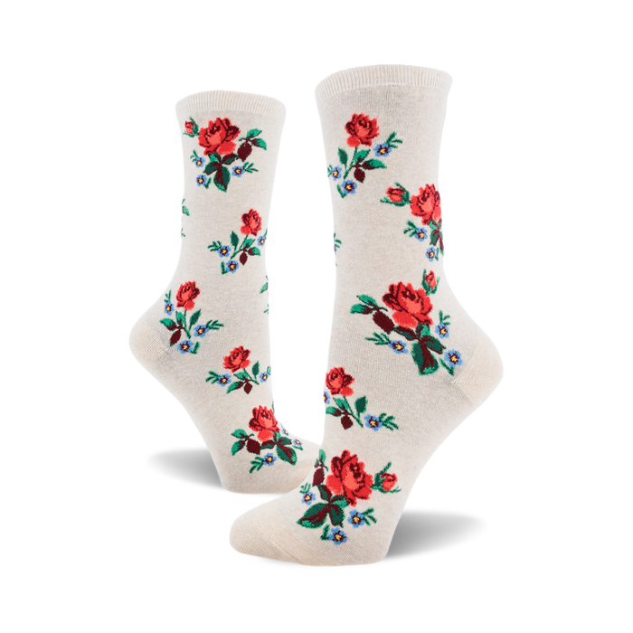 socks with a pattern of red roses with green stems and blue and white flowers with green stems. the background of the socks is off-white. }}