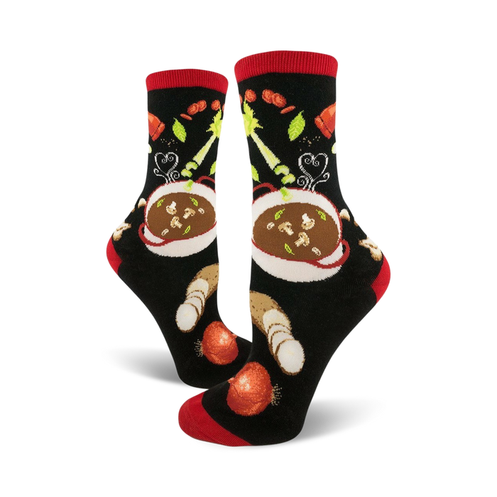 A pair of black crew socks with a red cuff, featuring a whimsical illustration of a bowl of soup and vegetables. }}
