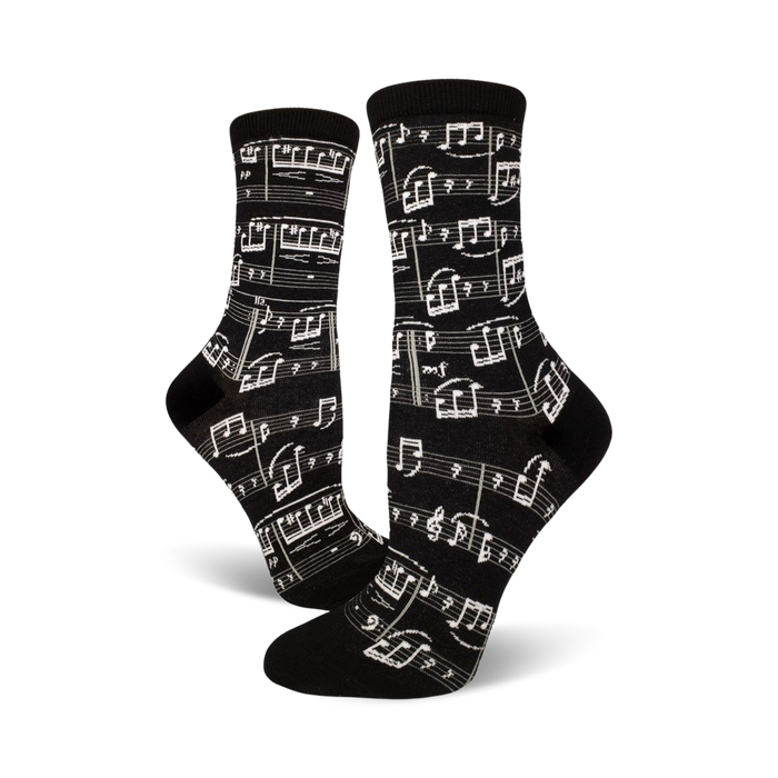 Pair of black crew socks with a musical notation print.  Clean, crisp white notes and musical symbols on a black background.