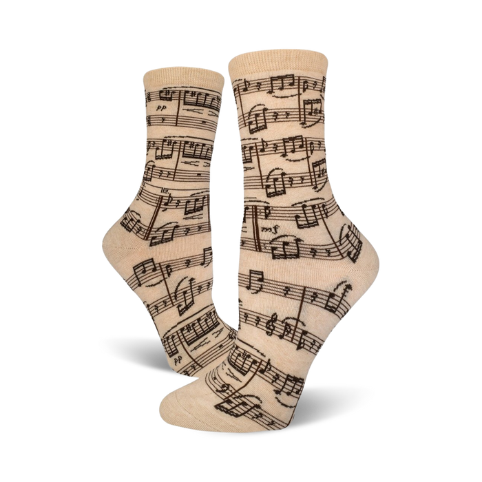 Close-up of beige crew socks with a musical notation print.  Dark brown notes on a beige background.