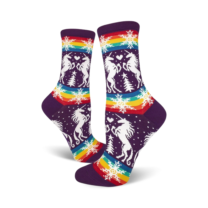 womens purple crew socks with pattern of two unicorns facing each other with a christmas tree between them; snowflakes and rainbow stripes in the background. gay apparel.   }}