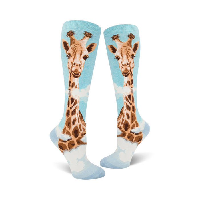Pair of women's knee-high socks. Light blue background with a whimsical giraffe design in shades of brown and tan.