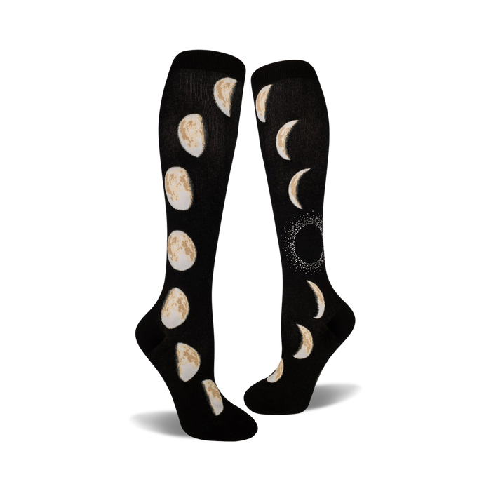 Pair of black knee-high socks showcasing the eight phases of the moon in beige/off-white. }}