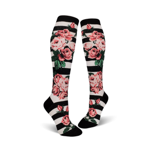Close-up of Romantic Rose knee-high socks on a black and white striped background, showcasing the floral details.