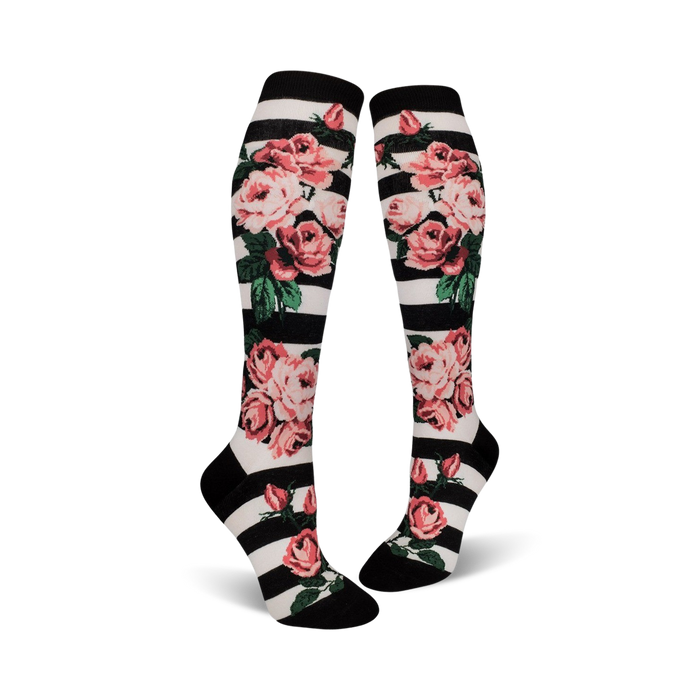 Close-up of Romantic Rose knee-high socks on a black and white striped background, showcasing the floral details.