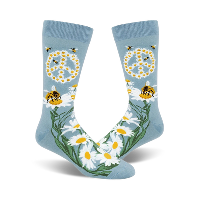A pair of light blue crew socks with a peace symbol made of daisies, busy bees, and green stems. A whimsical and nature-inspired design.
