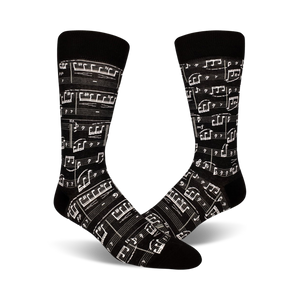 Pair of crew socks, black and beige options, featuring a printed musical score design.