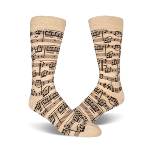 Close-up lifestyle shot of beige musical note socks on a person's feet.