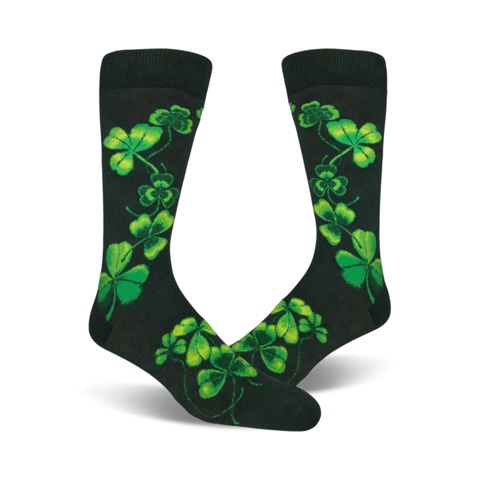 Pair of dark-green crew socks adorned with bright-green shamrock designs. The shamrocks are arranged in a playful, cascading pattern. }}