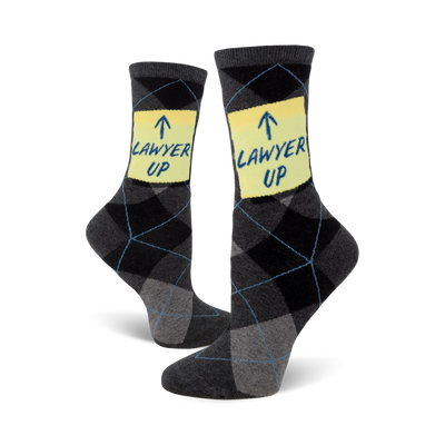 Pair of gray and black argyle crew socks. A yellow post-it note on each sock says 'LAWYER UP!' in blue.